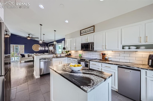 8084 Cinnamon Ct, Colorado Springs, CO 80927 - kitchen featuring appliances with stainless steel finishes, a sink, open floor plan, ceiling fan, and white cabinets