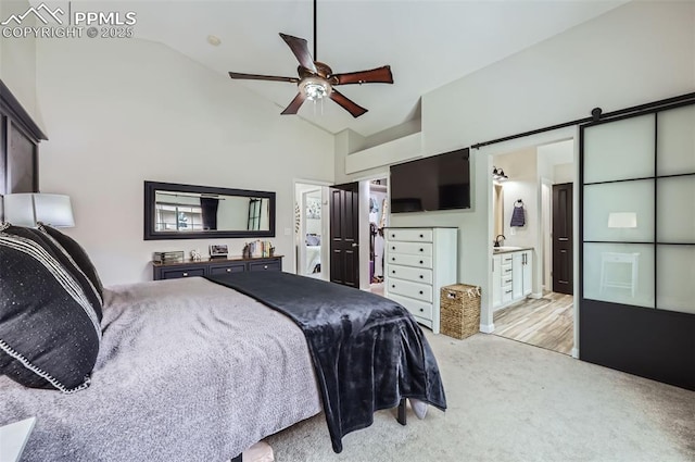 8084 Cinnamon Ct, Colorado Springs, CO 80927 - bedroom featuring high vaulted ceiling, light carpet, a barn door, connected bathroom, and ceiling fan