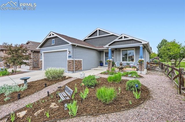 8084 Cinnamon Ct, Colorado Springs, CO 80927 - craftsman inspired home with an attached garage, concrete driveway, and stone siding