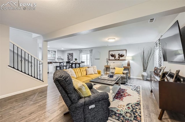 8084 Cinnamon Ct, Colorado Springs, CO 80927 - living room featuring wood-type flooring, stairs, and baseboards
