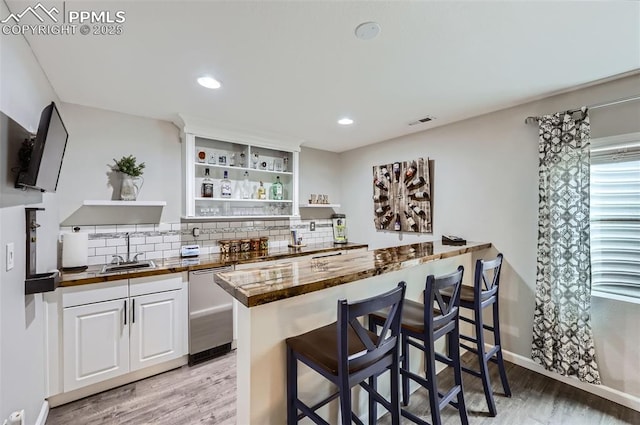 8084 Cinnamon Ct, Colorado Springs, CO 80927 - kitchen featuring open shelves, stainless steel dishwasher, a sink, wooden counters, and a kitchen breakfast bar