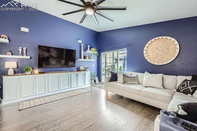 8084 Cinnamon Ct, Colorado Springs, CO 80927 - living room with wood finished floors, a ceiling fan, a textured wall, and baseboards