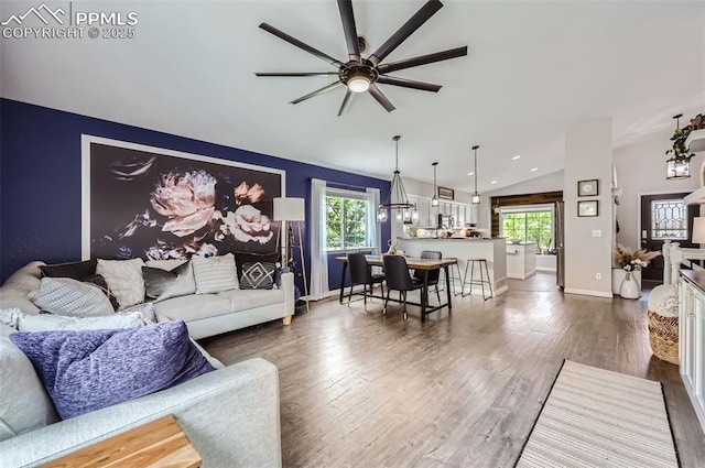 8084 Cinnamon Ct, Colorado Springs, CO 80927 - living room with vaulted ceiling, healthy amount of natural light, ceiling fan, dark wood-style floors, and baseboards