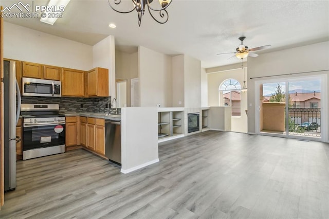 4710 Sand Mountain Pt, Colorado Springs, CO 80923 - kitchen with stainless steel appliances, light wood finished floors, tasteful backsplash, open floor plan, and a ceiling fan