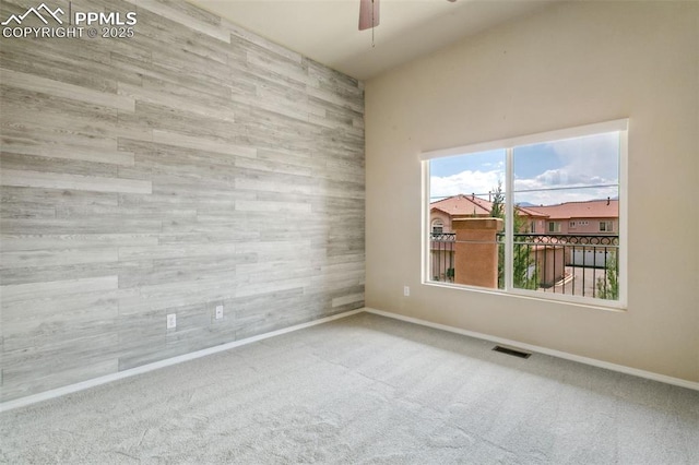 4710 Sand Mountain Pt, Colorado Springs, CO 80923 - carpeted empty room featuring ceiling fan and wood walls