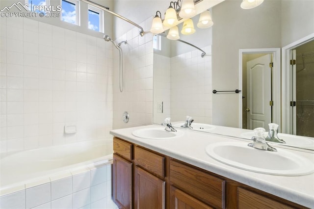 4710 Sand Mountain Pt, Colorado Springs, CO 80923 - full bath with tiled shower / bath combo, double vanity, and a chandelier