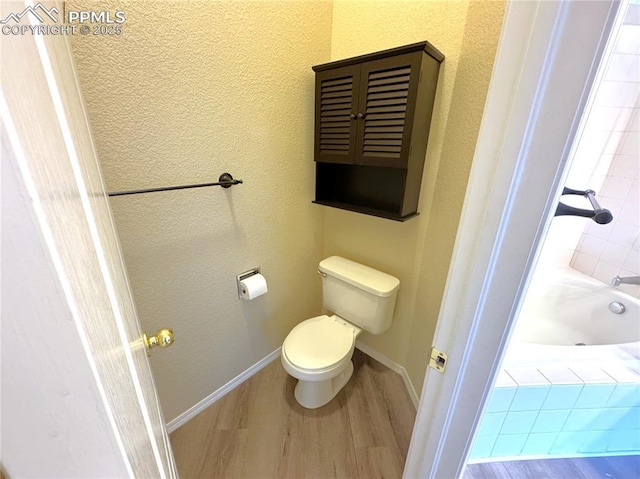 4710 Sand Mountain Pt, Colorado Springs, CO 80923 - bathroom with wood finished floors and a tub