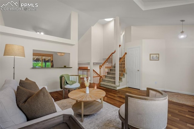 4125 Cricket Ct, Colorado Springs, CO 80918 - living area featuring wood finished floors, stairs, and high vaulted ceiling