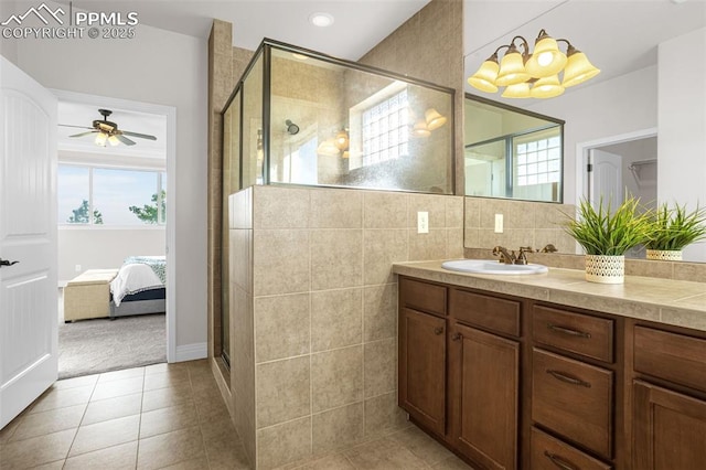 16255 Ridge Run Dr, Colorado Springs, CO 80908 - ensuite bathroom featuring a stall shower, a ceiling fan, vanity, tile patterned floors, and healthy amount of natural light
