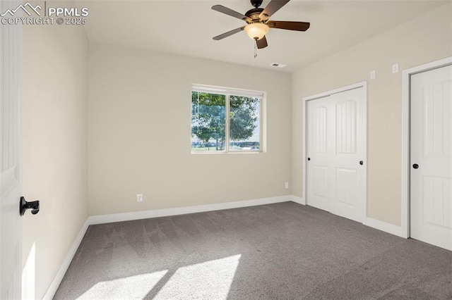 16255 Ridge Run Dr, Colorado Springs, CO 80908 - unfurnished bedroom featuring dark carpet, two closets, and a ceiling fan
