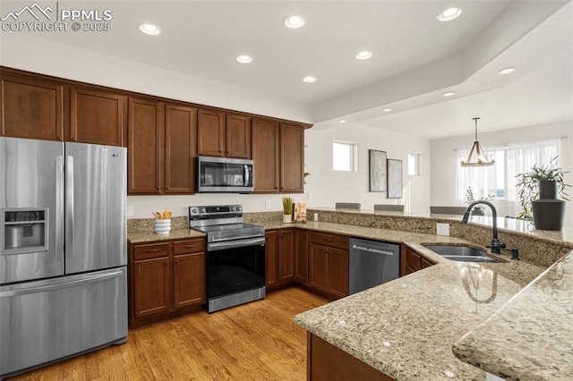 16255 Ridge Run Dr, Colorado Springs, CO 80908 - kitchen with stainless steel appliances, healthy amount of natural light, recessed lighting, light wood finished floors, and hanging light fixtures