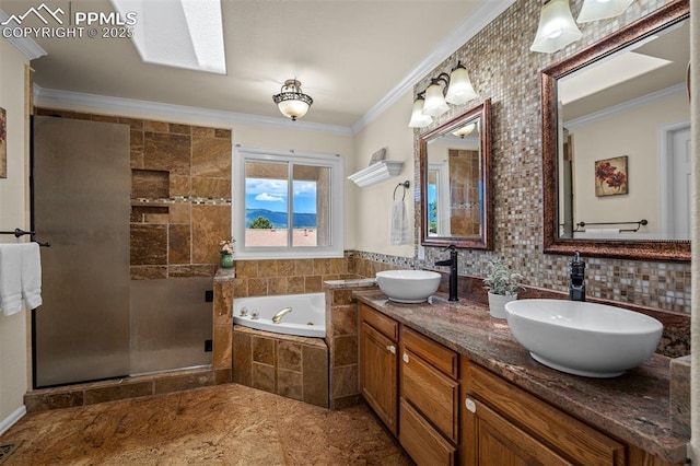 206 Luxury Ln, Colorado Springs, CO 80921 - bathroom featuring a whirlpool tub, double vanity, a stall shower, crown molding, and a skylight