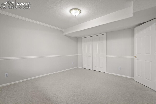 206 Luxury Ln, Colorado Springs, CO 80921 - unfurnished bedroom with carpet flooring, a textured ceiling, ornamental molding, and a closet