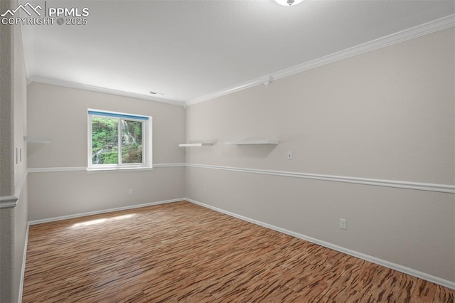 206 Luxury Ln, Colorado Springs, CO 80921 - empty room featuring crown molding and wood finished floors