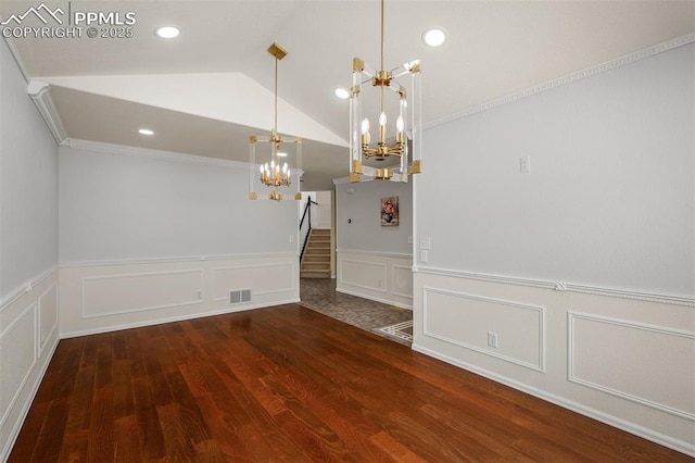 206 Luxury Ln, Colorado Springs, CO 80921 - unfurnished dining area with a chandelier, a decorative wall, wainscoting, lofted ceiling, and crown molding