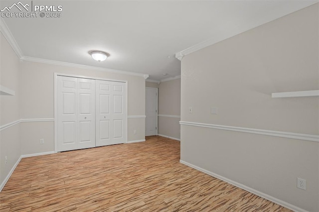 206 Luxury Ln, Colorado Springs, CO 80921 - unfurnished bedroom featuring wood finished floors, ornamental molding, and a closet