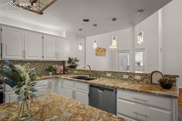 206 Luxury Ln, Colorado Springs, CO 80921 - kitchen featuring stainless steel dishwasher, light stone countertops, backsplash, white cabinets, and hanging light fixtures