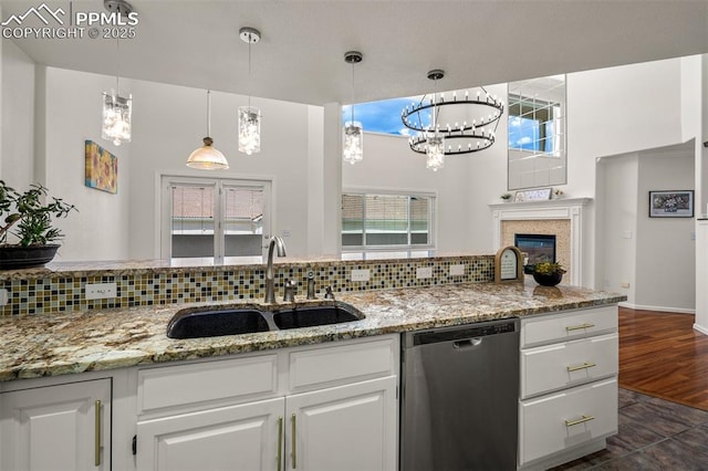 206 Luxury Ln, Colorado Springs, CO 80921 - kitchen with stainless steel dishwasher, tasteful backsplash, white cabinetry, and a high ceiling