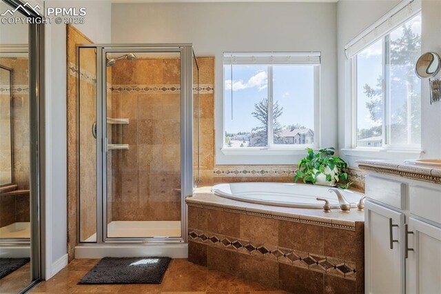 14095 Gleneagle Dr, Colorado Springs, CO 80921 - bathroom featuring tile patterned flooring, a garden tub, a stall shower, and healthy amount of natural light