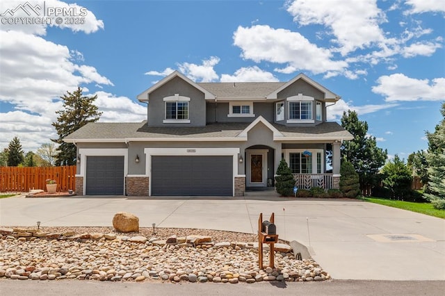 14095 Gleneagle Dr, Colorado Springs, CO 80921 - view of front of house featuring stucco siding, concrete driveway, covered porch, and stone siding