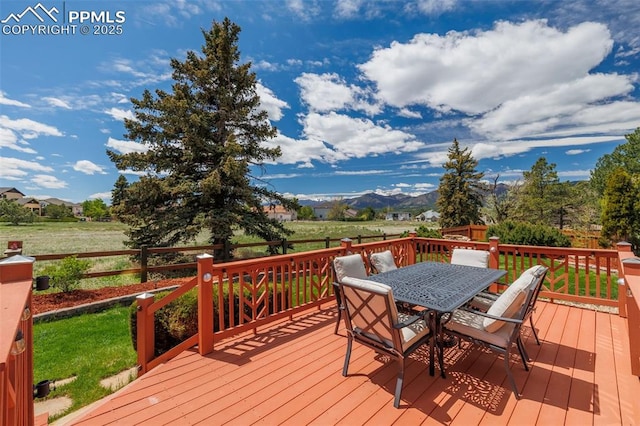 14095 Gleneagle Dr, Colorado Springs, CO 80921 - wooden terrace with outdoor dining area, a mountain view, and a lawn