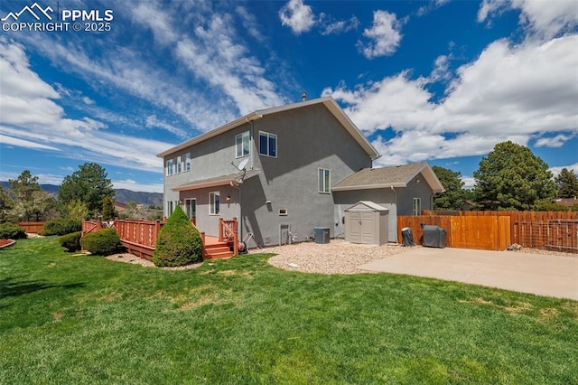 14095 Gleneagle Dr, Colorado Springs, CO 80921 - back of house with stucco siding, a storage unit, a patio, and a deck