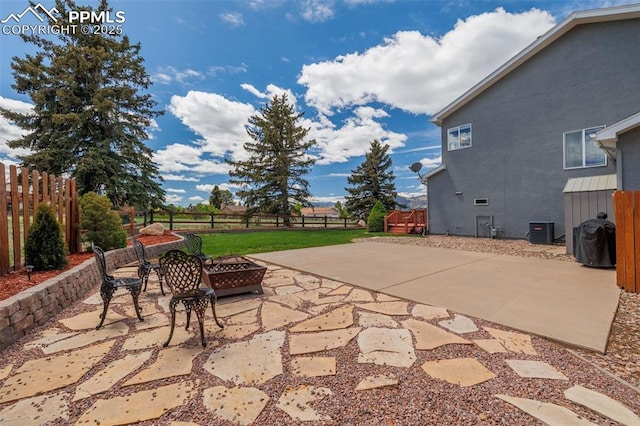 14095 Gleneagle Dr, Colorado Springs, CO 80921 - fenced backyard featuring an outdoor fire pit and a patio