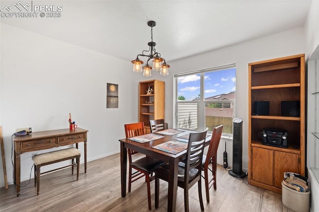 1749 Victorian Pt, Colorado Springs, CO 80905 - dining space with light wood-style floors and a chandelier