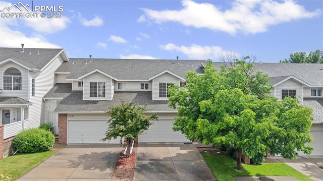 1749 Victorian Pt, Colorado Springs, CO 80905 - view of front facade featuring roof with shingles, driveway, and a garage