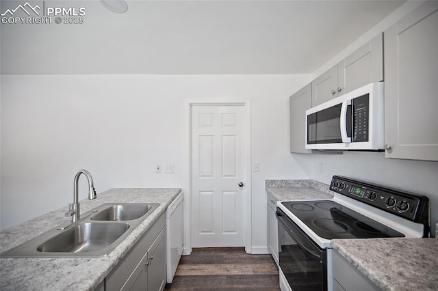 3014 N Moonbeam Cir, Colorado Springs, CO 80916 - kitchen with white appliances, dark wood-type flooring, light countertops, and gray cabinetry