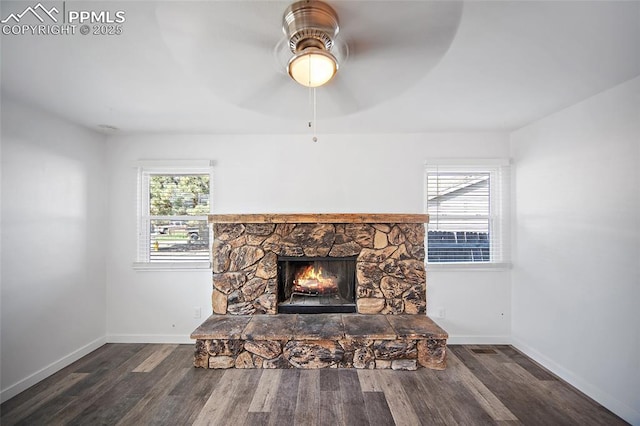 3014 N Moonbeam Cir, Colorado Springs, CO 80916 - detailed view of wood finished floors, ceiling fan, and a stone fireplace