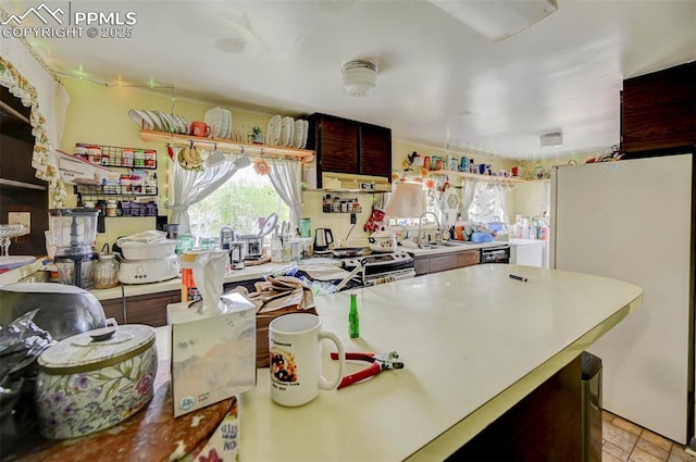 128 W Eaton Ave, Cripple Creek, CO 80813 - kitchen featuring freestanding refrigerator, light countertops, a sink, and electric stove