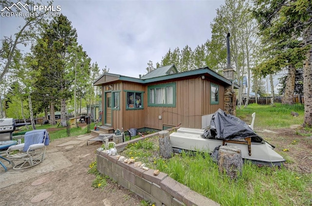 128 W Eaton Ave, Cripple Creek, CO 80813 - view of side of home with metal roof and a patio area