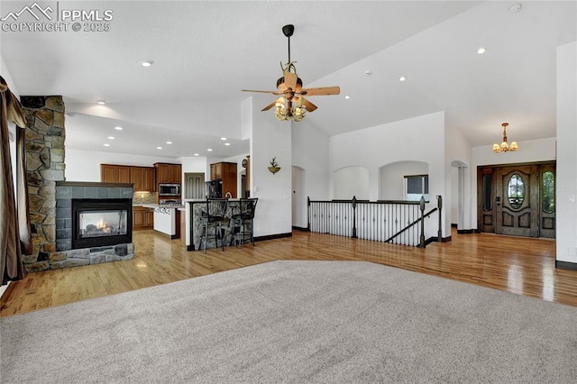 11354 Mckissick Rd, Peyton, CO 80831 - living area featuring ceiling fan, light wood finished floors, high vaulted ceiling, recessed lighting, and arched walkways