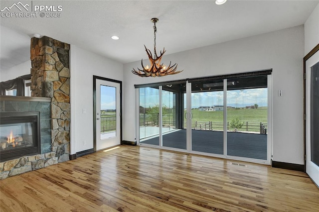 11354 Mckissick Rd, Peyton, CO 80831 - unfurnished living room featuring a chandelier, wood finished floors, healthy amount of natural light, and recessed lighting