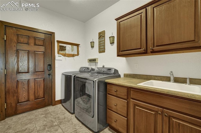 11354 Mckissick Rd, Peyton, CO 80831 - laundry area with cabinet space, washing machine and clothes dryer, and light tile patterned flooring