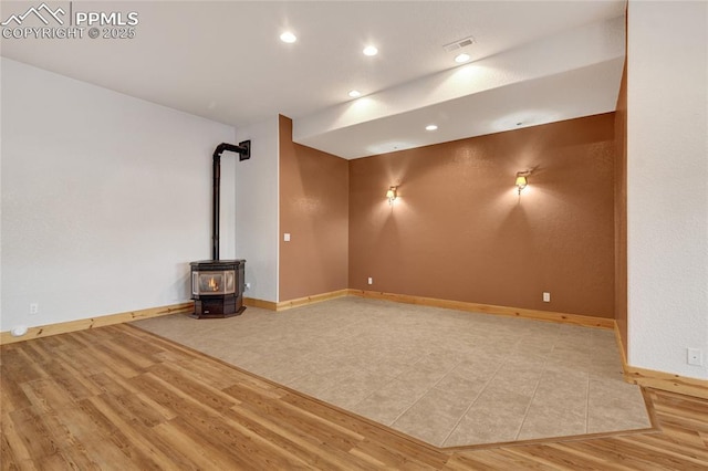 11354 Mckissick Rd, Peyton, CO 80831 - unfurnished room with a wood stove, wood finished floors, and recessed lighting