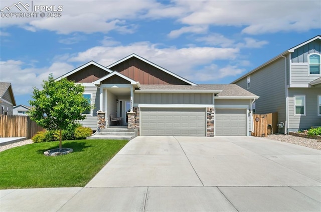 6862 Simcoe Dr, Colorado Springs, CO 80925 - craftsman-style home featuring board and batten siding, a garage, driveway, stone siding, and a shingled roof