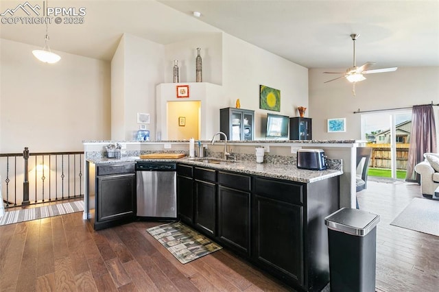 6862 Simcoe Dr, Colorado Springs, CO 80925 - kitchen with dishwasher, a sink, dark cabinetry, open floor plan, and dark wood-type flooring