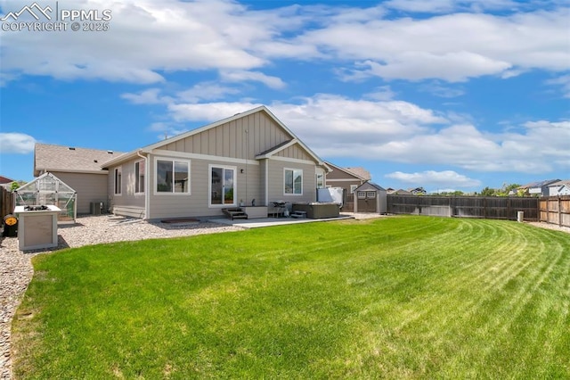 6862 Simcoe Dr, Colorado Springs, CO 80925 - rear view of house with board and batten siding, a patio, and central AC unit