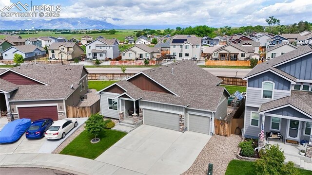 6862 Simcoe Dr, Colorado Springs, CO 80925 - view of front of property featuring a residential view, concrete driveway, an attached garage, and roof with shingles