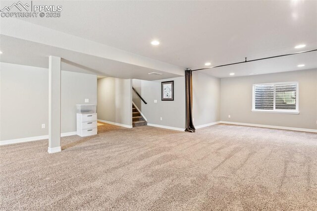 6862 Simcoe Dr, Colorado Springs, CO 80925 - basement with light carpet, recessed lighting, stairs, and baseboards