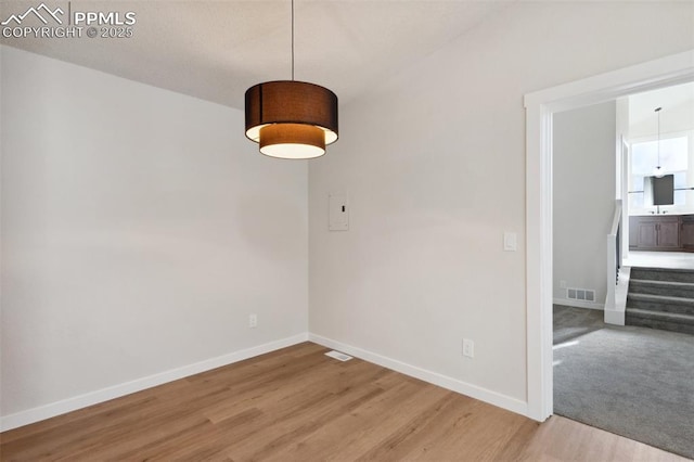 629 E Monument St, Colorado Springs, CO 80903 - unfurnished dining area featuring baseboards and light wood-type flooring