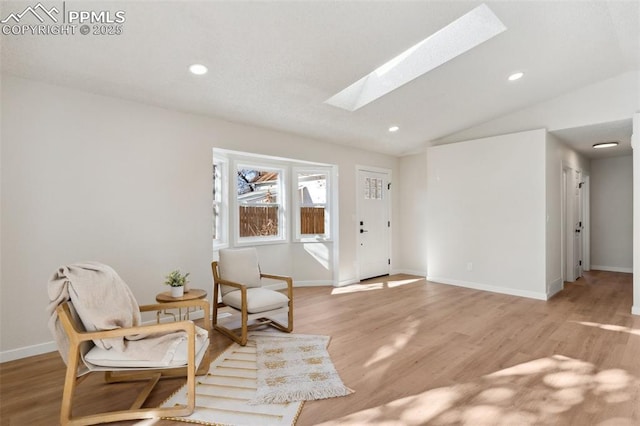 629 E Monument St, Colorado Springs, CO 80903 - sitting room with a skylight, vaulted ceiling, light wood finished floors, recessed lighting, and baseboards