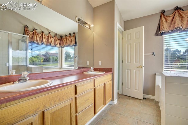 55 Misty Creek Dr, Monument, CO 80132 - full bath with double vanity, a shower stall, a bath, and tile patterned flooring