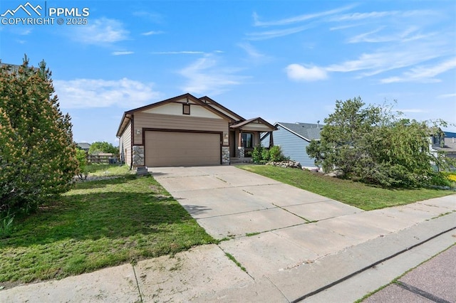 55 Misty Creek Dr, Monument, CO 80132 - view of front of house with an attached garage, a front yard, driveway, and stone siding