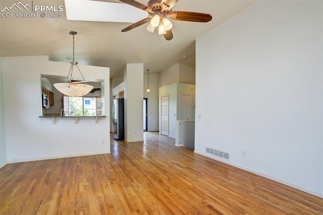 55 Misty Creek Dr, Monument, CO 80132 - unfurnished living room with vaulted ceiling, light wood-type flooring, and ceiling fan
