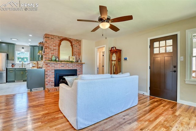 1445 N Foote Ave, Colorado Springs, CO 80909 - living area with a ceiling fan, light wood finished floors, a brick fireplace, and recessed lighting