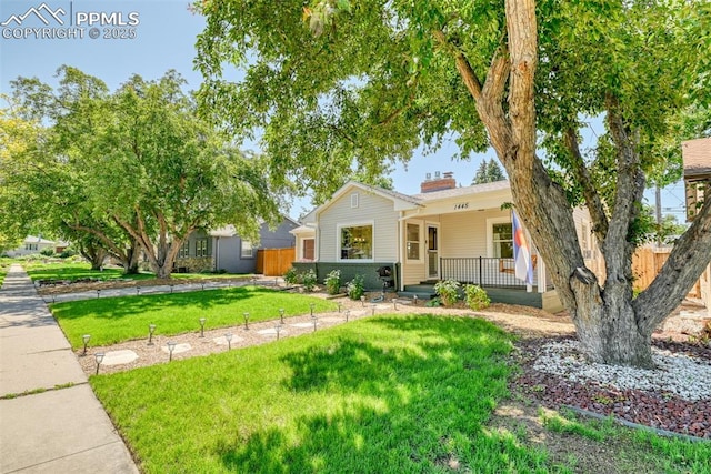 1445 N Foote Ave, Colorado Springs, CO 80909 - view of front facade with a porch and a chimney