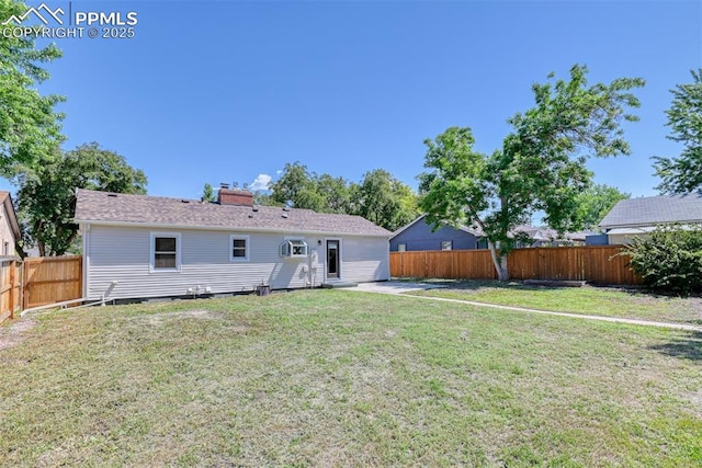 1445 N Foote Ave, Colorado Springs, CO 80909 - back of house featuring a fenced backyard and a chimney